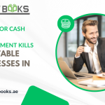 Stressed business owner reviewing dwindling bank statements in a Dubai office, symbolizing how poor cash flow management kills profitable companies.