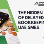 Stack of unsorted receipts and financial documents piling up next to a calculator, symbolizing the financial risks of delayed bookkeeping for UAE small businesses.