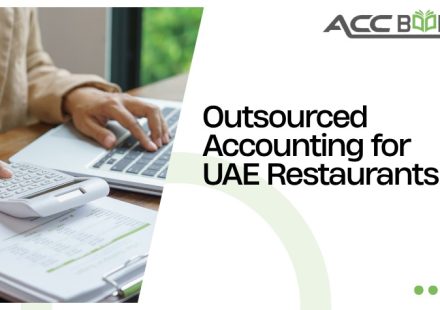 Accountant reviewing a ledger and restaurant receipts on a wooden desk in a UAE cafe, highlighting outsourced accounting for hospitality finance management.