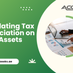Accountant calculating tax depreciation on fixed assets using a laptop, calculator, and asset register spreadsheet with UAE corporate tax guidelines